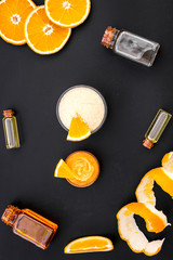 organic cosmetics for homemade spa with orange oil black background top view pattern