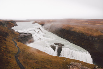 Panoramic photos of famous Icelandic waterfalls on cloudy days with geological formations.