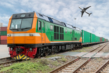 Obraz premium Cargo train platform with freight train container at depot with cargo airplane in port use for export logistics background.