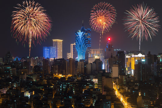 New Year’s fireworks at Macau (Macao), China. Skyscraper hotel and casino building at downtown in Macau (Macao).