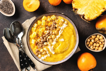 Top view of mango smoothie bowl with fruits