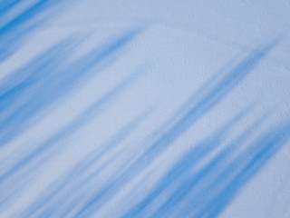 Obraz premium Aerial view on the texture of snow with shadow from trees on the surface of a winter lake 
