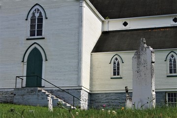 The old cemetery and St. George's Church, Brigus, Newfoundland and Labrador. View of old headstones and church.