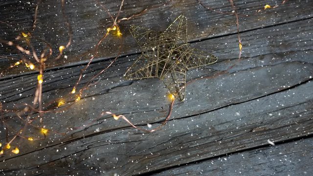 Falling snow with Christmas lights on wood