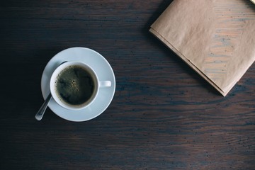  concentrated black rich coffee americano on a wooden table made of solid oak and black notes