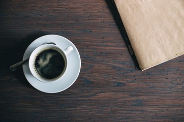  concentrated black rich coffee americano on a wooden table made of solid oak and black notes