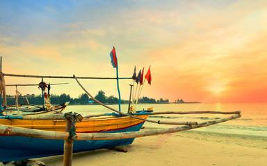 Wooden fishing boat during sunset beach.