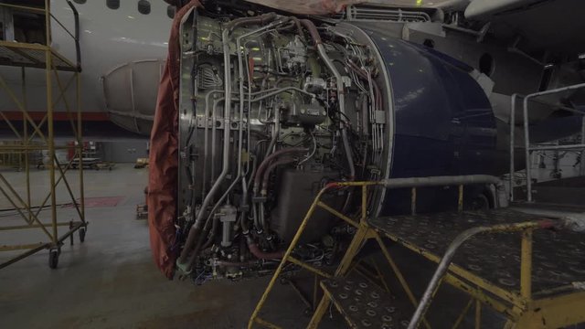 Jet engine under going repairs inside an airplane hanger