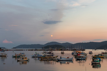 Fototapeta premium Sunset with the moon rising in Paraty, Rio de Janeiro