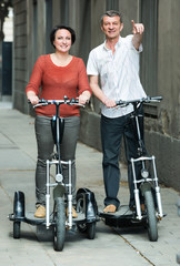 Fototapeta na wymiar Mature couple staying with electric bikes