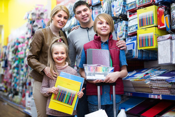 Family choosing stationery in store.