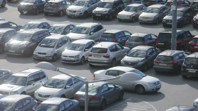 Silver automobile driving at car park. Parking lot full of autos. Outdoors, idea, lifestyle. City vibes. Top view. Urbanization.