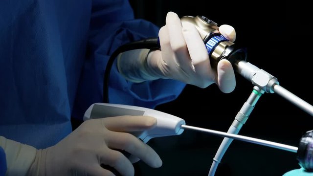 Medical Laparoscopic surgical training operation surgeons using Endoscope and Laparoscope instruments wearing surgical gloves and scrubs 