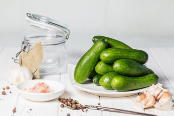 Ingredients for cooking pickled cucumbers on white background.