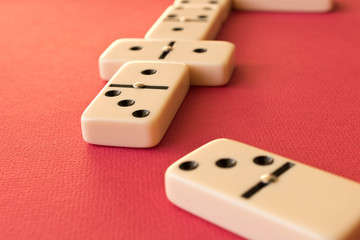 Playing dominoes on a red background . Domino concept