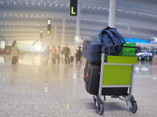 Many luggage are in the cart at the airport, ready for check-in a long holiday. Concept traveling by airplane is very popular.