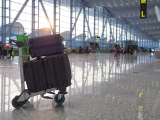 Many luggage are in the cart at the airport, ready for check-in a long holiday. Concept traveling by airplane is very popular.