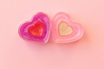 Two funny hearts on a pink background. The concept of Valentine's day