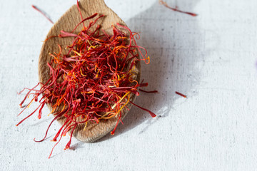 Dried saffron spice in a spoon, copy space