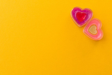 Two funny hearts on a yellow background. The concept of Valentine's day