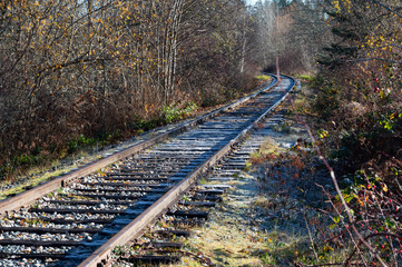 Disused railway line during winter with frost on track