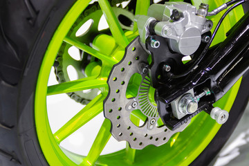 Detail Motorcycle wheel in black and green with ABS brakes part of the motorcycle.