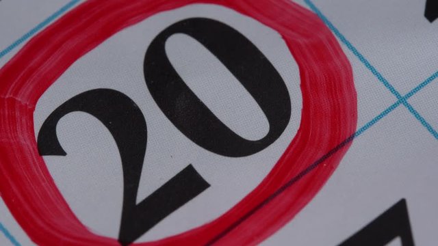 Marking the date in the calendar with a red marker. The twentieth day of the month