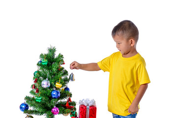 Happy asian child holding little bell for decoration Christmas tree. Christmas or happy newyear time
