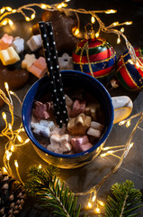 Cup of milk and Marshmallow. Christmas lights