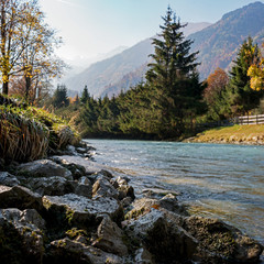 Autumn season. Beautiful view of the Austrian Alps with colorful nature, trees, leaves and a stream in Kaprun, Austria. Kaprun is located near the town of Zell am see