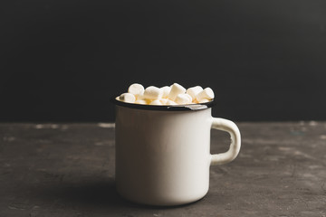Sweet hot chocolate in mug. Christmas drink with marshmallow. Selective focus. Shallow depth of field. 