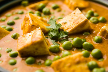 Green peas or matar paneer curry recipe, served in a bowl. selective focus