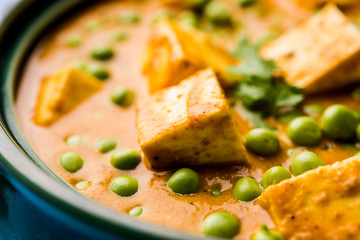 Green peas or matar paneer curry recipe, served in a bowl. selective focus