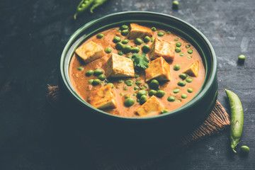 Green peas or matar paneer curry recipe, served in a bowl. selective focus