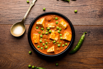 Green peas or matar paneer curry recipe, served in a bowl. selective focus