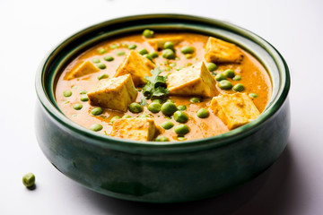 Green peas or matar paneer curry recipe, served in a bowl. selective focus