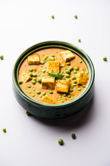 Green peas or matar paneer curry recipe, served in a bowl. selective focus