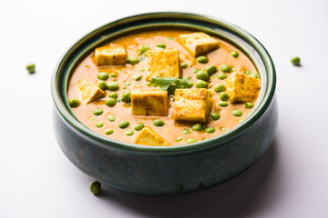 Green peas or matar paneer curry recipe, served in a bowl. selective focus