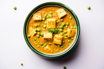 Green peas or matar paneer curry recipe, served in a bowl. selective focus