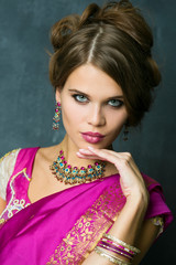 Beautiful fashion Indian woman portrait with oriental accessories earrings