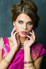 Beautiful fashion Indian woman portrait with oriental accessories earrings