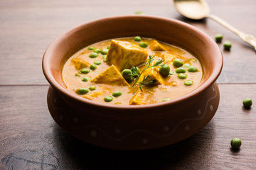 Green peas or matar paneer curry recipe, served in a bowl. selective focus