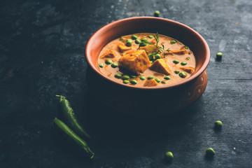 Green peas or matar paneer curry recipe, served in a bowl. selective focus