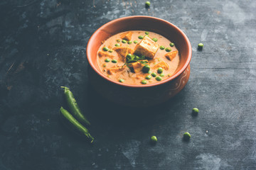 Green peas or matar paneer curry recipe, served in a bowl. selective focus