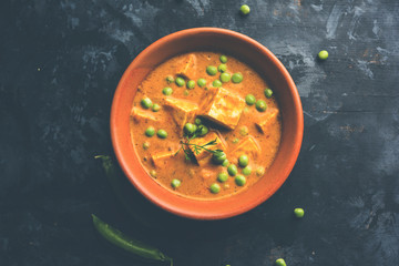 Green peas or matar paneer curry recipe, served in a bowl. selective focus