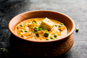 Green peas or matar paneer curry recipe, served in a bowl. selective focus