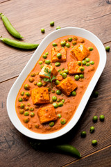 Green peas or matar paneer curry recipe, served in a bowl. selective focus
