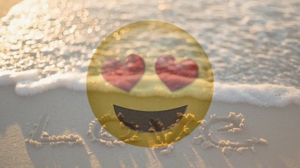 Happy smiling love smiley and love written in the sand for valentine day