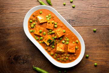 Green peas or matar paneer curry recipe, served in a bowl. selective focus