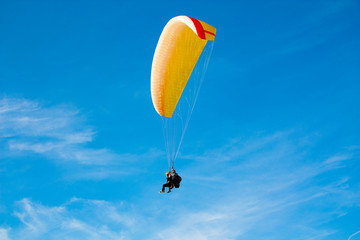paraglider on the background of bright blue sky